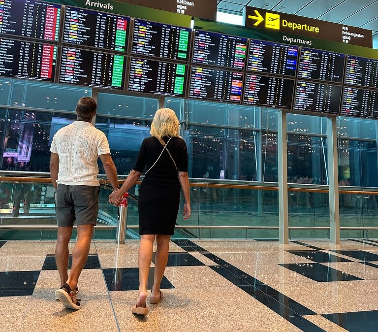 Shayne and Shelly at the airport checkingo out the departure board