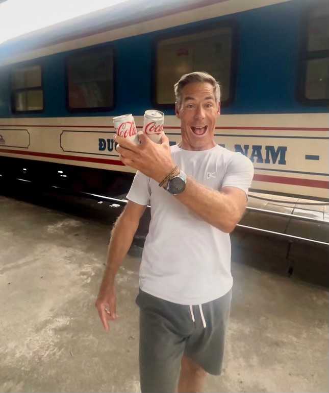 Shayne grabbing some diet coke at a train station in Vietnam