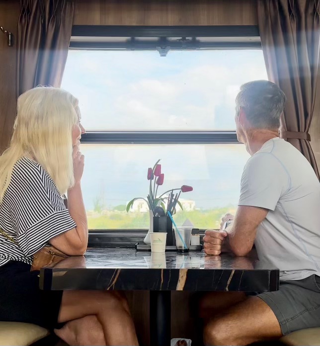 Shayne and Shelly on a train in Vietnam looking out the window