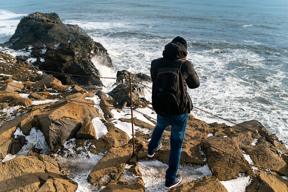 Man Taking picture of ocean