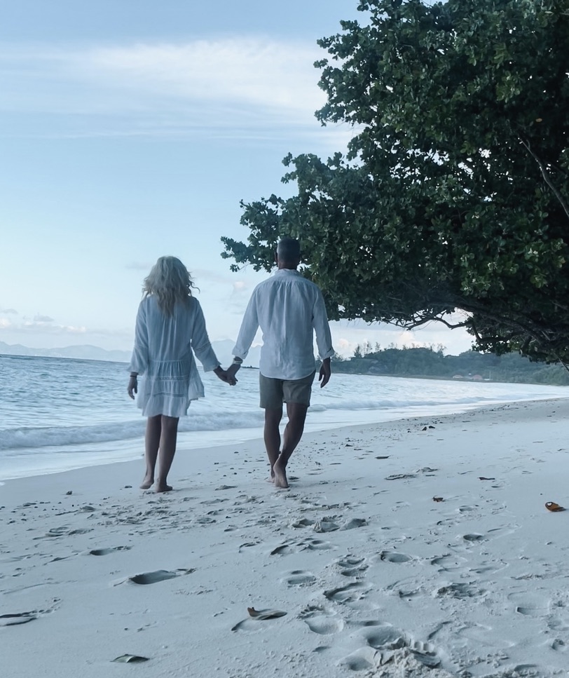 Shayne and Shelly on the beach in the Seychelles chasing sunshine.