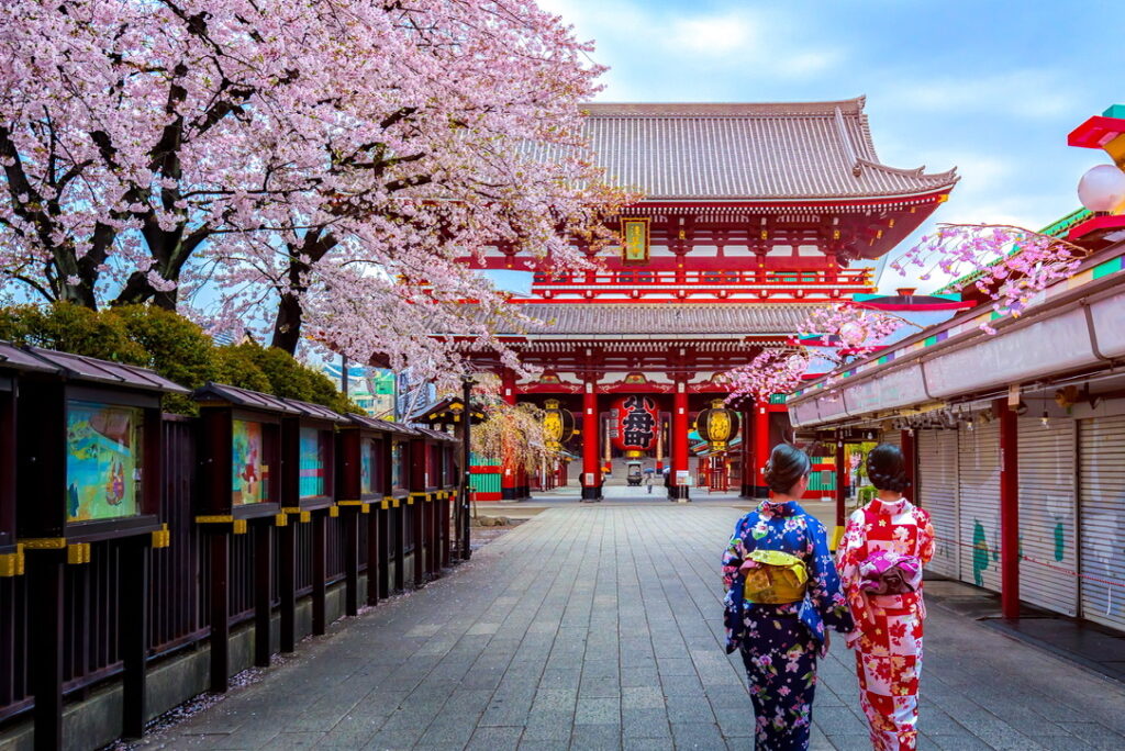 Two women wearing traditional japanese kimono among Sensoji Temple in Asakusa Tokyo, Japan.