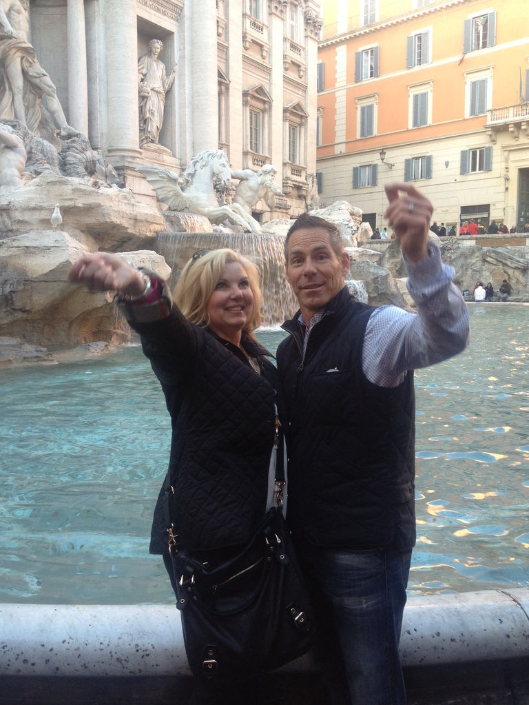 Couple tossing coins into the trevi fountain