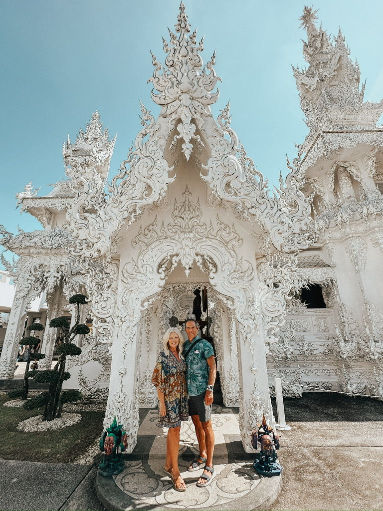 couple at the white temple in chiang rai thailand