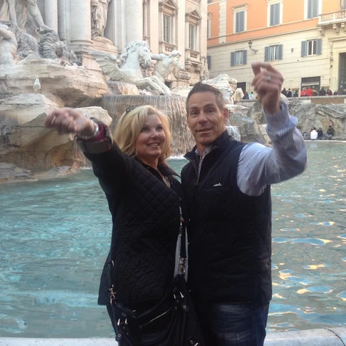 throwing a coin at the trevi fountain