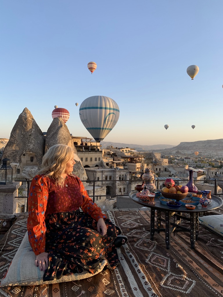 Shelly watching the hot air ballons in Cappadocia Turkey, one of the places where your travel dollar goes further.