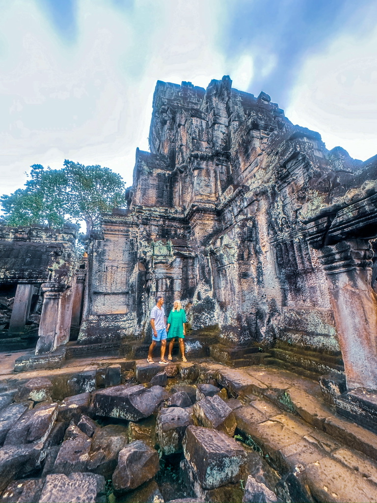 Shayne and Shelly walking through Angkor Wat in Cambodia, one of the places where your travel dollar goes further