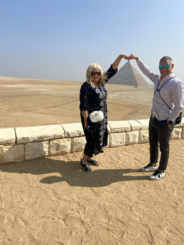 Shayne and Shelly visiting the Giza Pyramids in Egypt, one of the places where your travel dollar goes further.