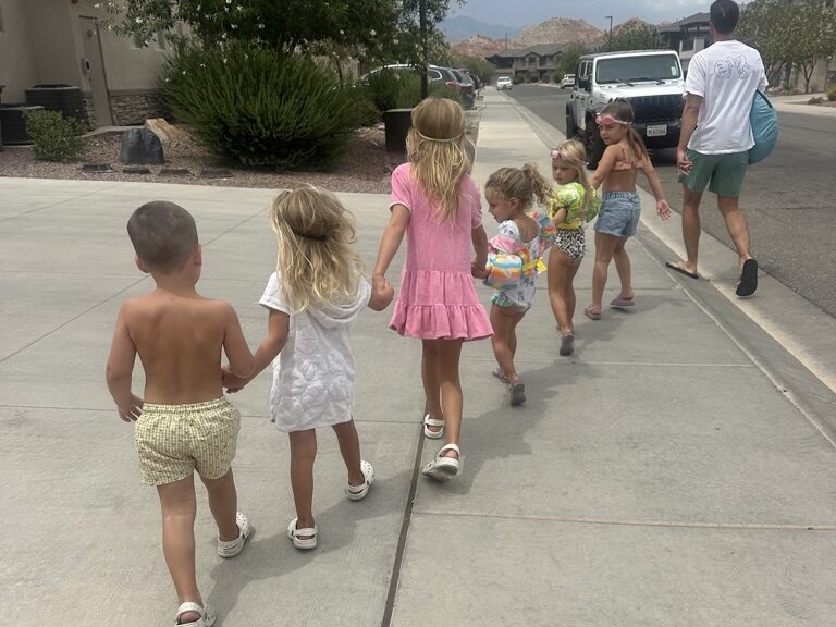 Grandkids walking to the resort style pool at our summer family reunion vacation rental