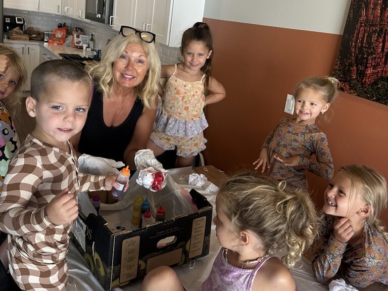 Grandmother and her grandkids going crafts at a family reunion